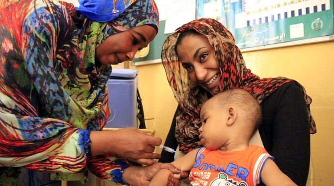 Eine sudanesische Ärztin (l) impft in Khartum (Sudan) in einer Klinik ein Kind gegen Masern. Foto: Morwan Ali