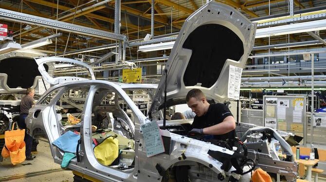 Mitarbeiter von Mercedes-Benz arbeiten im Werk in Bremen an einem C-Klasse Modell.