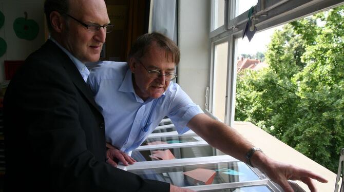 Wolfgang Kühn (links) und Ulrich Schwille zeigen auf schadhafte Stellen im Fensterrahmen.  GEA-FOTO: DÖRR