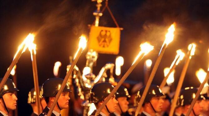 Soldaten des Wachbataillons halten am 28.04.2010 Fackeln während des Großen Zapfenstreichs in der Marineschule Mürwik in Flen