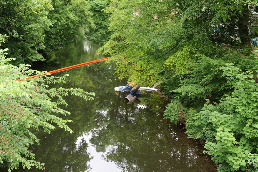 Kran zieht Baumaschine aus dem Neckar