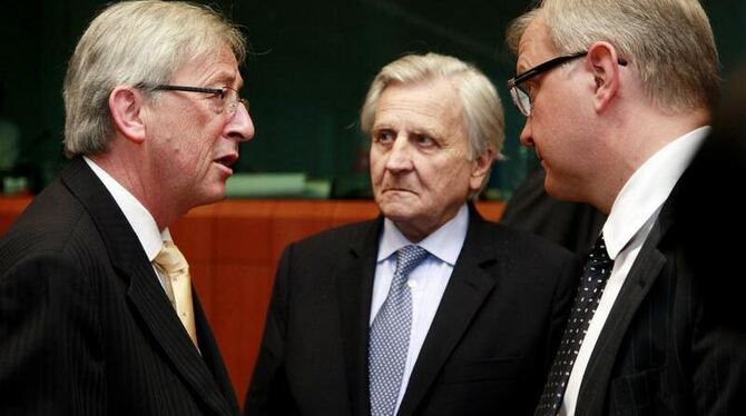 Der Vorsitzende der Euro-Finanzminister, Luxemburgs Jean-Claude Juncker spricht mit Jean-Claude Trichet und Olli Rehn (v.l.n.