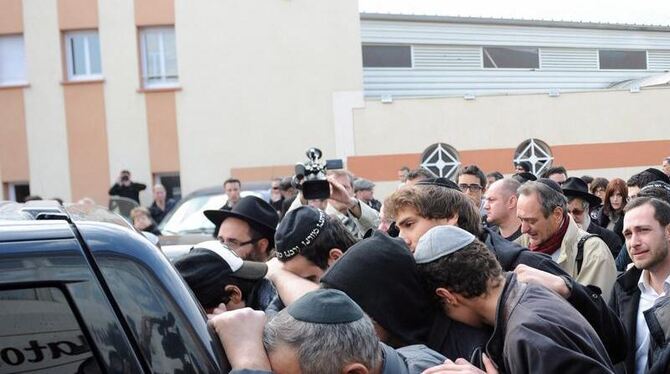 Mitglieder der jüdischen Gemeinde in Toulouse folgen einem Leichenwagen. Die vier Opfer der Bluttat von Toulouse werden in Je