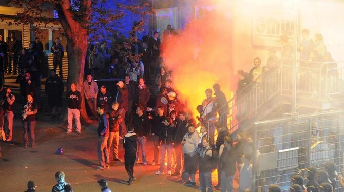 Karlsruher Fans belagern nach dem 2:2 Endstand die Geschäftsstelle und entzünden Feuerwerkskörper.