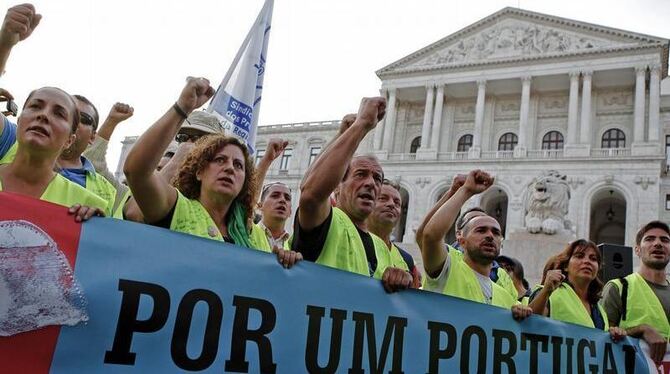 Menschen protestieren vor dem Parlamentsgebäude in Lissabon gegen die Sparpolitik der Regierung. Foto: Jose sena Goulao