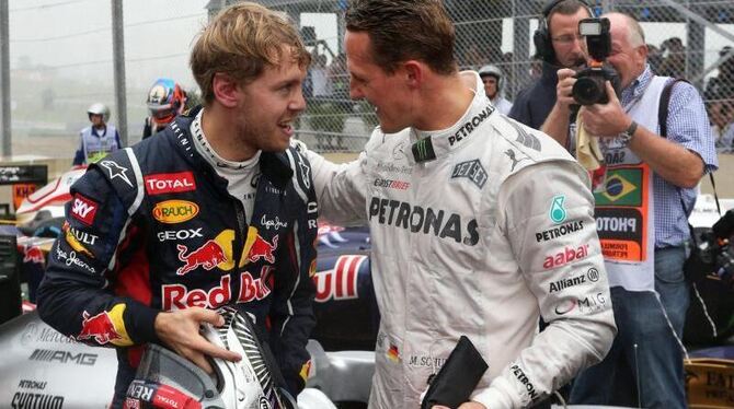 Sebastian Vettel (l) und Michael Schumacher verstehen sich. Foto: Jens Buettner