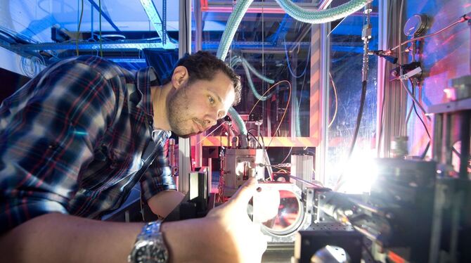 Florian Weckenmann, wissenschaftlicher Mitarbeiter an der Universität Stuttgart, arbeitet an einer Tropfenkammer. Foto: dpa