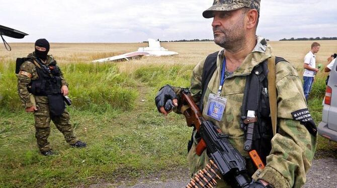 Bewaffnete kontrollieren die Absturzstelle bei Grabovo. Foto: Robert Ghement