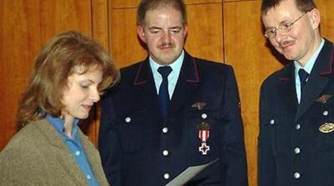 Eningens Bürgermeisterin Margarete Krug ehrte die beiden Feuerwehrmänner Martin Koch und Jochen Kurz (von links).  FOTO: KAB