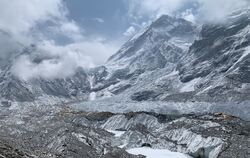 Das Himalaya-Gebirge. Ganz klein, auf der rechten Seite des Bildes stehen die gelben Zelte des Everest-Base-Camps, in dem sich d