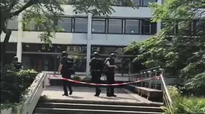 Bewaffnete Polizisten in schusssicheren Westen und Schutzhelmen gehen ins Reutlinger Rathaus, um nach einem Mann mit Pistole zu
