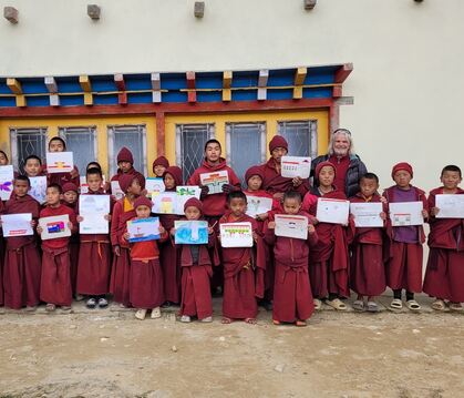 Schülerinnen und Schüler der Klosterschule Taksindu halten Bilder, die sie für ihre Partnerschule in Ravensburg gemalt haben.