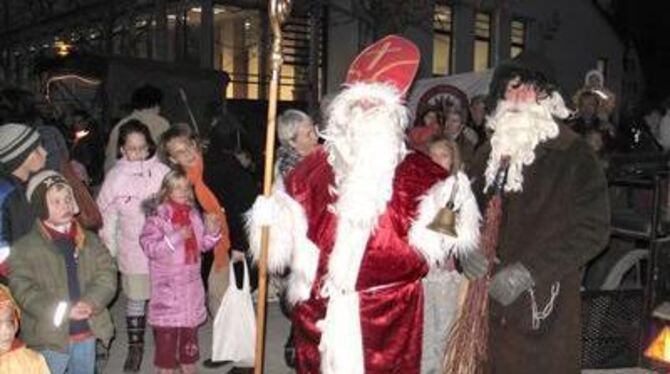 Klassiker der Vorweihnachtszeit auf dem Wannweiler Markt: Nikolaus mit Knecht Ruprecht vor beeindruckter Kinderschar. FOTOS: SAN