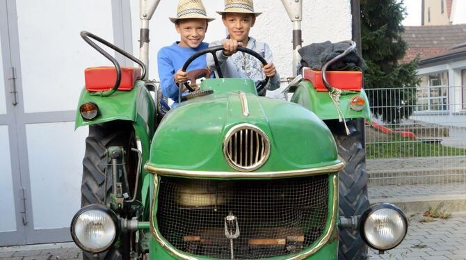 Marian (links) und Valentin Kurz durften auf dem Traktor Probe sitzen. FOTO: VEY