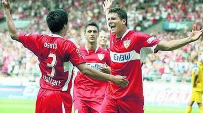 Ricardo Osorio (links) jubelt über den 21. Treffer von Mario Gomez in dessen 65. Spiel für den VfB Stuttgart.  
FOTO: DPA