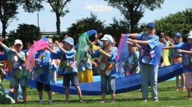 In leuchtenden Farben erzählten Jungen und Mädchen beim großen Kinderfest in Walddorfhäslach die Geschichte vom Regenbogenfisch.